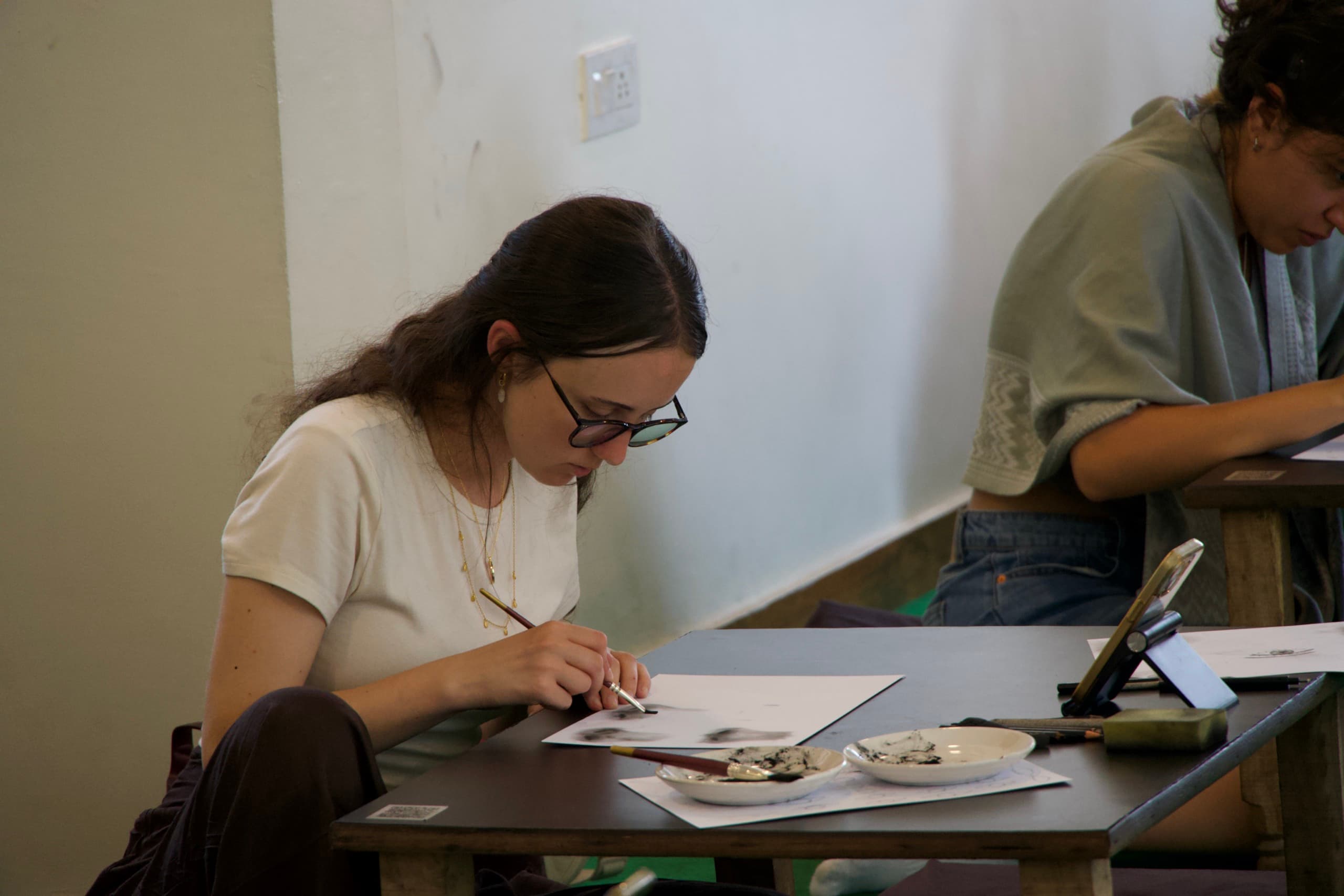 Students focused on charcoal drawing practice at the Science of Sketching studio